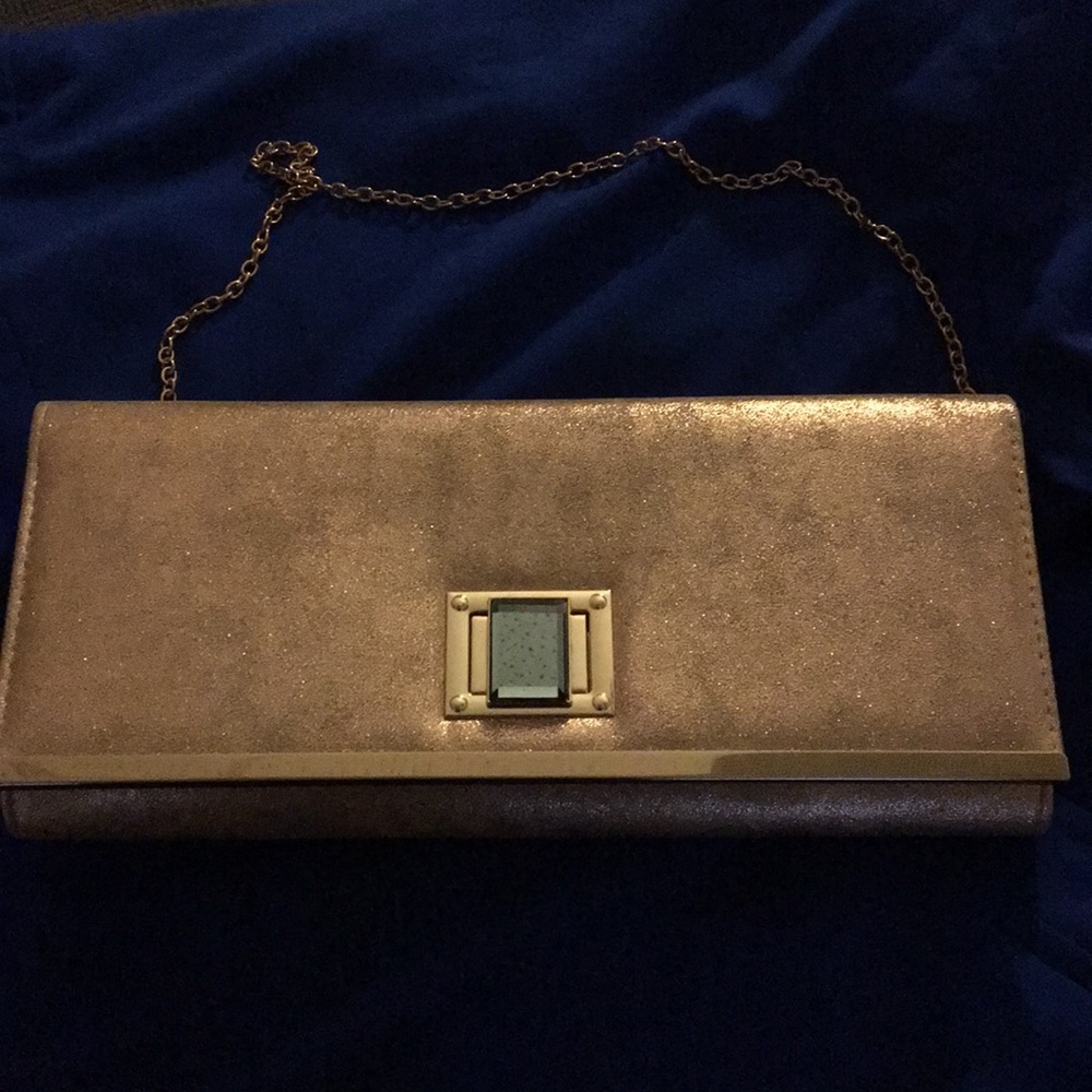 Gold clutch purse with glass button closure